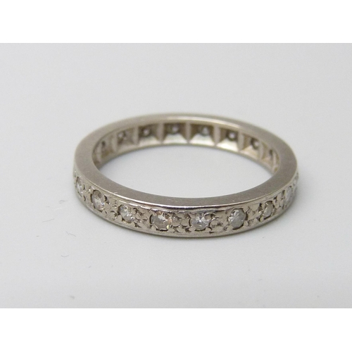 986 - A white metal and diamond eternity ring, 3.4g, L