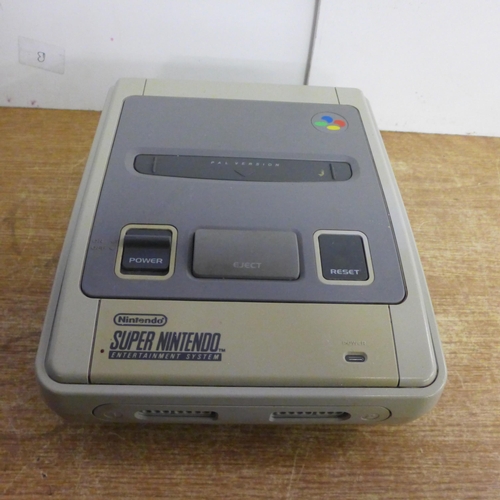 2119 - A Nintendo Super Nintendo Entertainment System console with a controller and two games including Sup... 