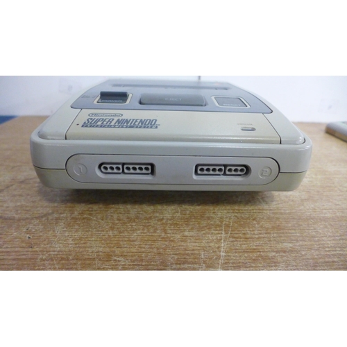 2119 - A Nintendo Super Nintendo Entertainment System console with a controller and two games including Sup... 