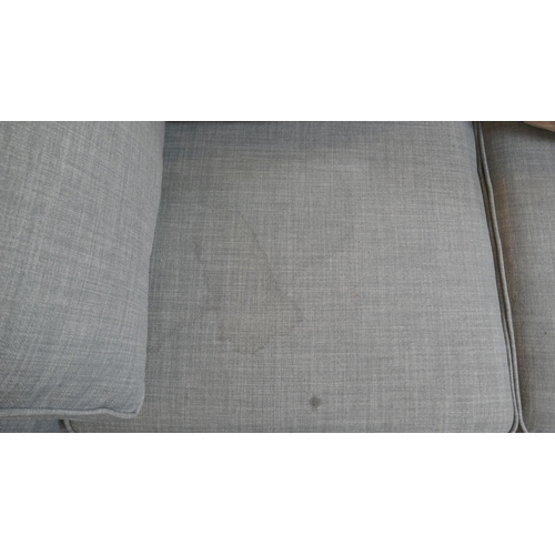 1543 - A grey upholstered two seater sofa - stained