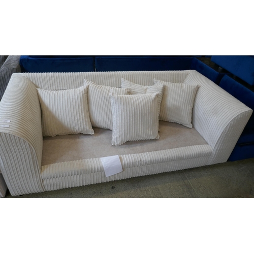 1564 - A cream corded three seater sofa and footstool - missing cushions