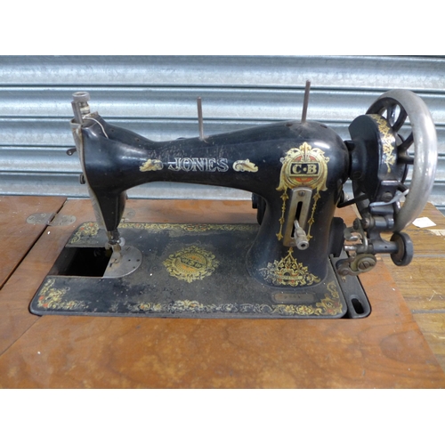 2161 - A vintage Jones treadle sewing machine with sewing machine table