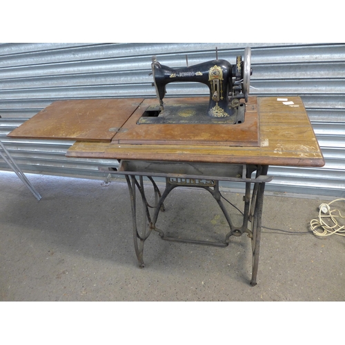 2161 - A vintage Jones treadle sewing machine with sewing machine table