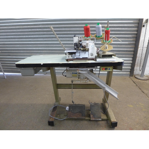 2162 - A Brother EF4-B531 industrial overlocking machine on table base with swivel machinist's chair