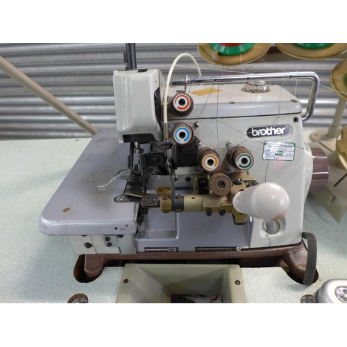 2162 - A Brother EF4-B531 industrial overlocking machine on table base with swivel machinist's chair