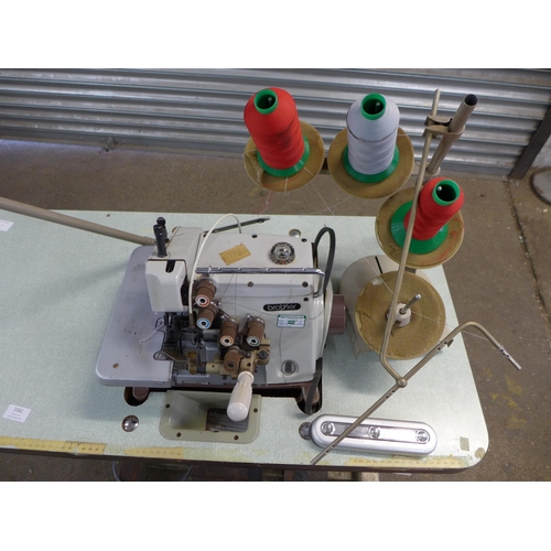 2162 - A Brother EF4-B531 industrial overlocking machine on table base with swivel machinist's chair