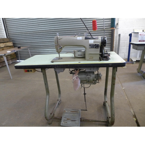 2163 - A Consew model 230 industrial sewing machine on cast metal base