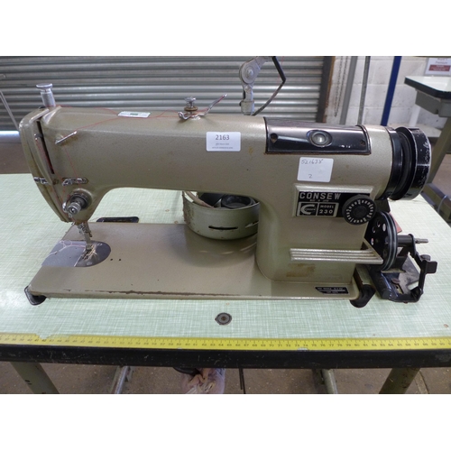 2163 - A Consew model 230 industrial sewing machine on cast metal base