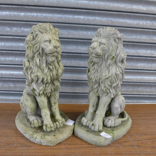 2218 - A pair of concrete garden lion ornaments, approx. 17