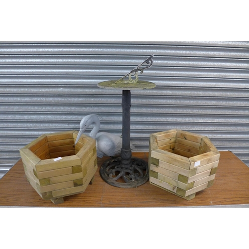 2222 - Two hexagonal wooden garden planters, a plastic heron garden ornament and a cast metal sun dial