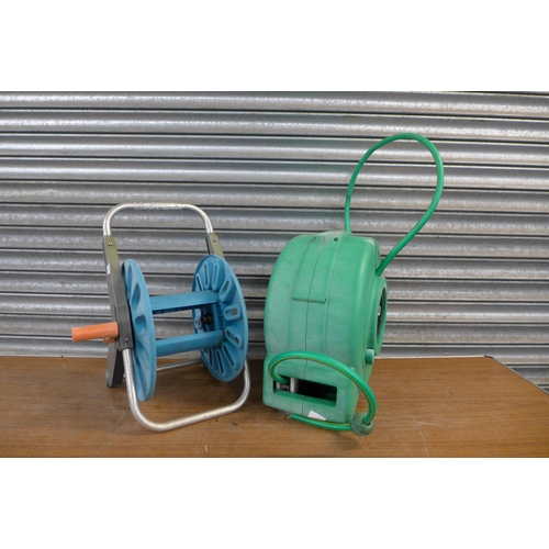 2223 - A Hozelock hose pipe and reel with spare reel