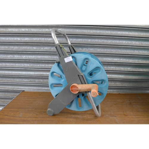 2223 - A Hozelock hose pipe and reel with spare reel