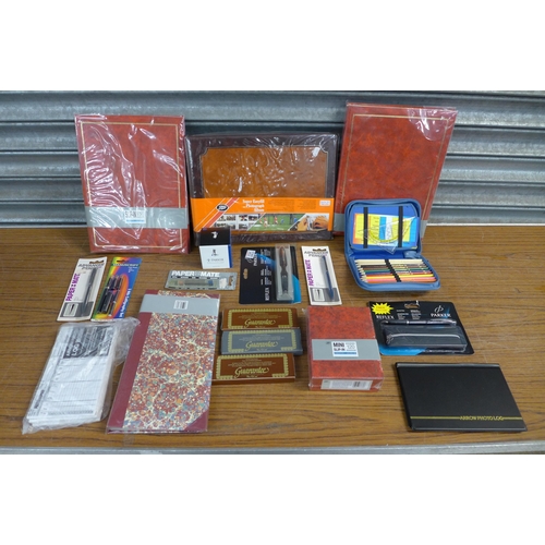 2302 - 2 Boxes of stationary and other items including seven photo albums, 2 portfolio cases, envelopes, pe... 