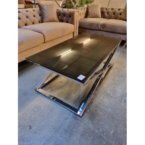 1538A - A Black glass and chrome 'x' base coffee table *This lot is subject to VAT