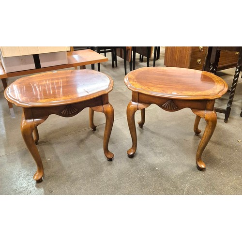 115 - A pair of Italian style mahogany and walnut lamp tables