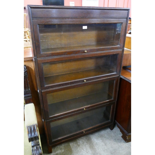 140 - An early 20th Century Gunn oak four tier sectional stacking bookcase