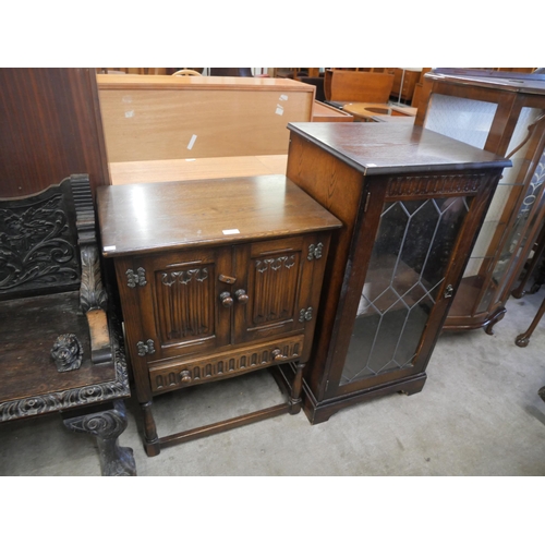 156 - A carved oak linenfold livery cupboard and a hi-fi cabinet