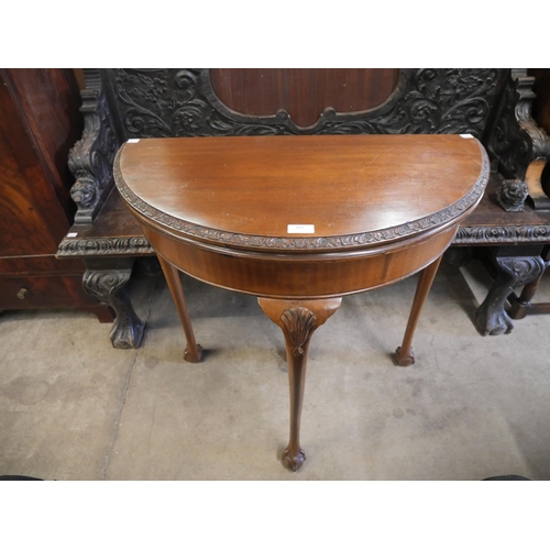 160 - A Queen Anne style mahogany demi lune card table