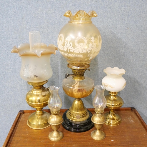 350 - A Victorian oil lamp and four early 20th Century brass oil lamps