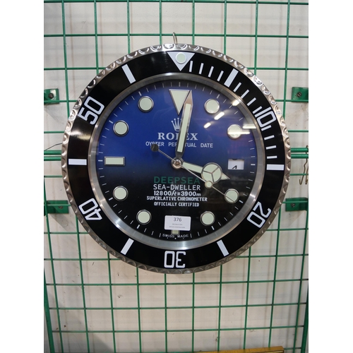 376 - A Rolex style dealers display wall clock