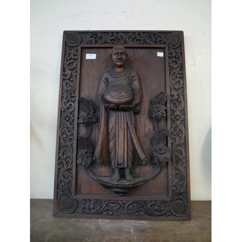 385 - A carved oak ecclesiastical wall plaque, depicting a monk