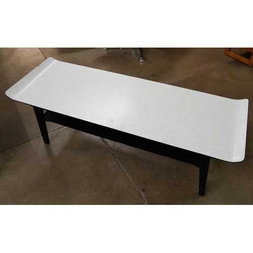 79 - A Formica sleigh topped coffee table