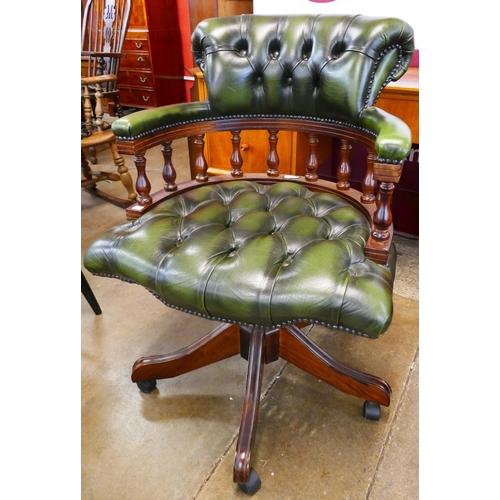 91 - A mahogany and green leather revolving Captains desk chair