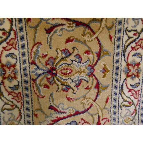 1342 - An ivory ground Cashmere carpet with all over floral pattern and gold border, 300 x 200