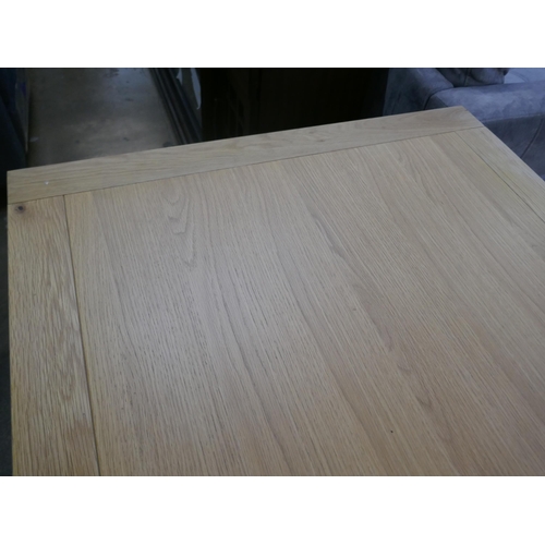 1450 - An oak dining table with white legs *This lot is subject to VAT