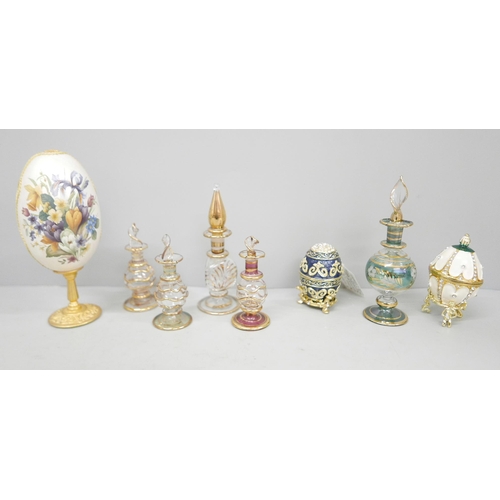 622 - Five glass perfume bottles, three enamelled and decorated brass eggs with hinged lids and one other ... 