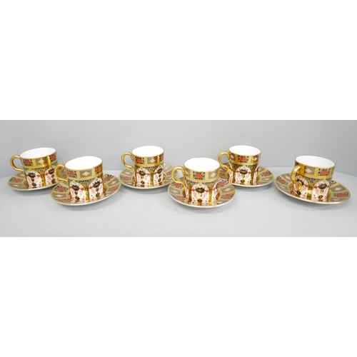 676 - A set of six Royal Crown Derby 1128 coffee cans and saucers