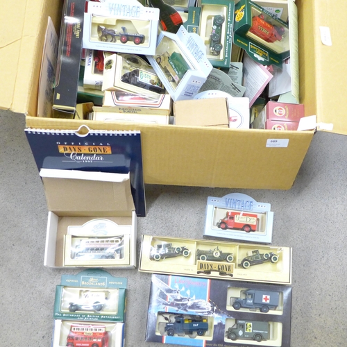 689 - A box of Lledo model vehicles, Comedy Classics, The Spirit of Brooklands, Famous Stores of London, D... 