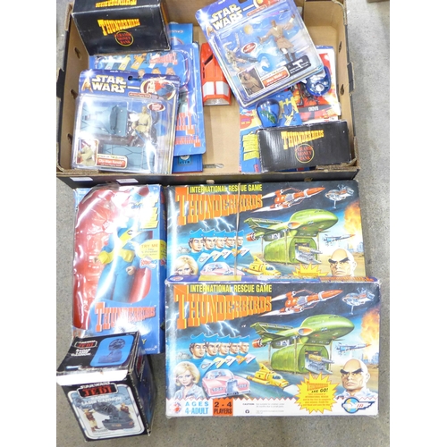 692 - A mixed lot of toys, Thunderbirds ceramic money banks, Thunderbirds International Rescue games, Star... 