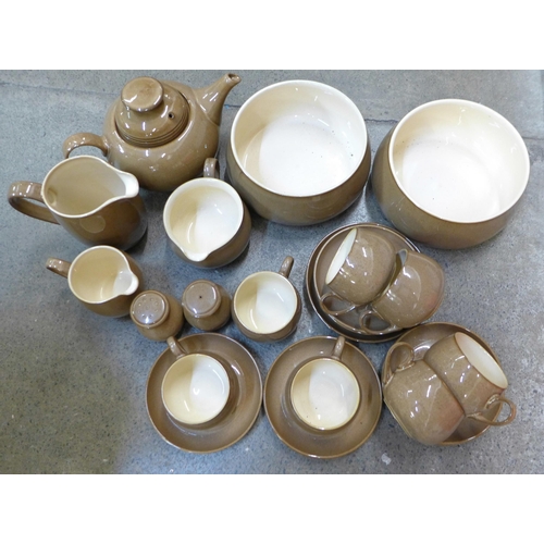 702 - Denby Pampas pottery; a teapot, seven cups, six saucers, salt and peper pots, 7