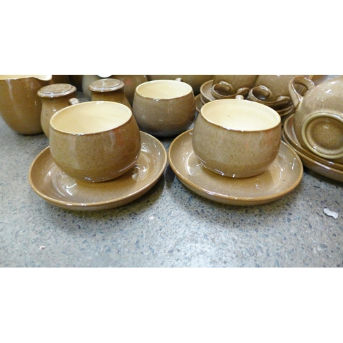 702 - Denby Pampas pottery; a teapot, seven cups, six saucers, salt and peper pots, 7