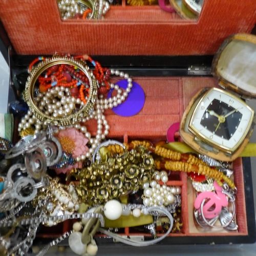 723 - A jewellery box and costume jewellery, and two cased travel clocks