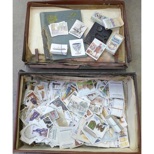 725 - A suitcase containing a collection of cigarette cards including Players, Ogdens and Wills