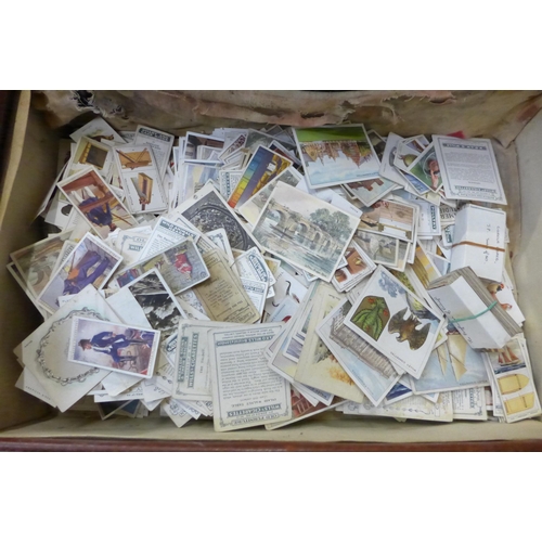 725 - A suitcase containing a collection of cigarette cards including Players, Ogdens and Wills