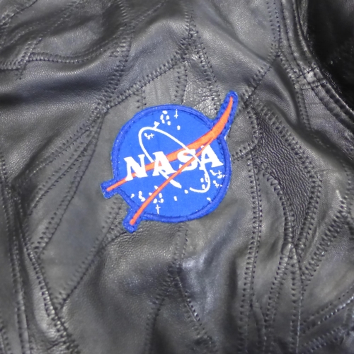729 - A NASA leather jacket with sewn space patches, size large, purchased at Kennedy Space Centre