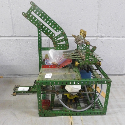 751 - A circa 1950s red/green Meccano Aunt Sally arcade game, coin operated with electric motor, 33cm wide