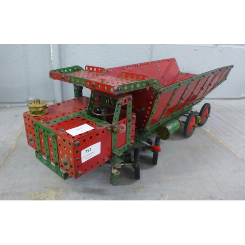 752 - A 1950s red/green Meccano dumper truck with working steering and tipping body, 65cm