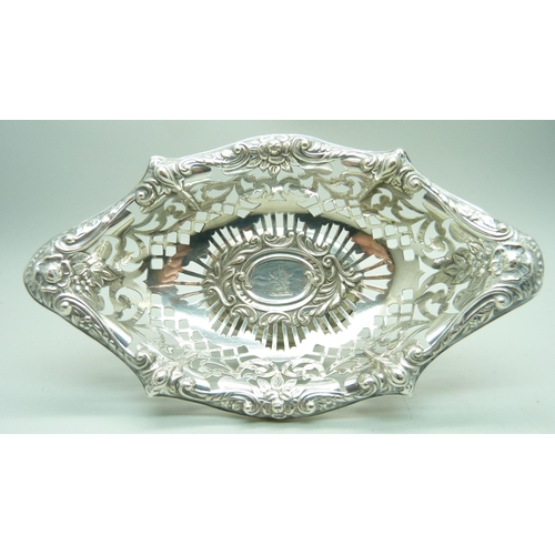 802 - A boat shaped embossed and pierced silver pedestal dish, crested, London 1898, 86g, 16.5cm