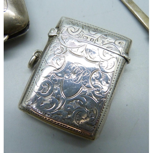 804 - Four silver items; sugar bows, vesta case, cigarette case and spoon, 123g