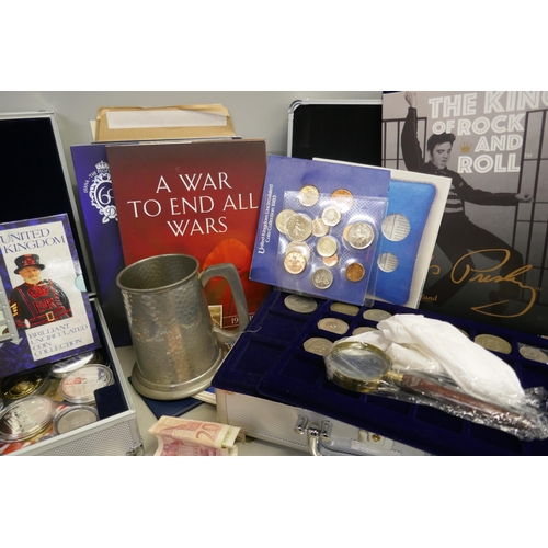 857 - A collection of coins in two aluminium cases; uncirculated coin sets, commemorative coins in cases a... 