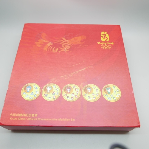 858 - A Beijing Olympics Ltd Young Master Athletics commemorative medallion set, made from gilt copper, no... 