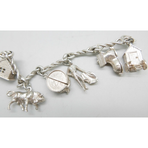 863 - A silver charm bracelet, 47g