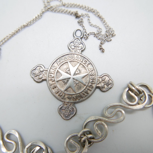 864 - A large scroll design 925 silver necklace, a silver cross pendant and chain and a silver St. Johns m... 