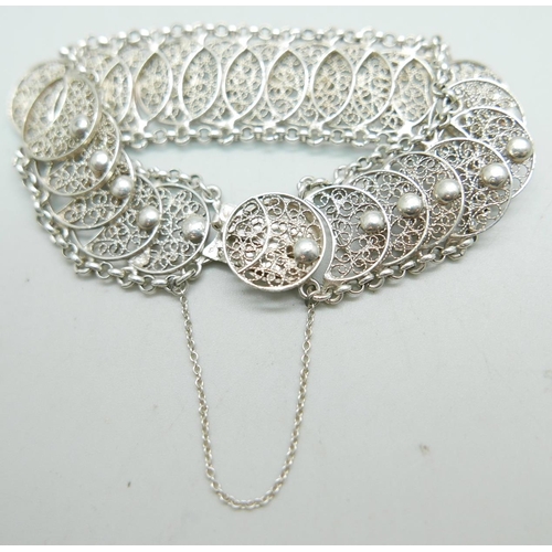 865 - A fancy continental filigree silver bracelet with French control marks, 27g