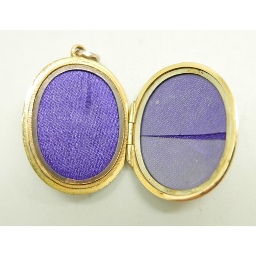 866 - A locket with applied gold and enamelled detail, 22mm wide, marked 9ct