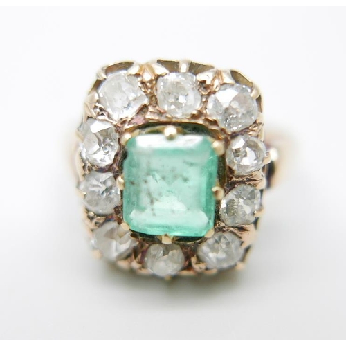 873 - A 19th Century yellow metal set emerald and diamond cluster ring, approximately 1.2ct diamond weight... 